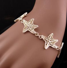 This beautiful never worn starfish bracelet would make a great gift for the ocean lover. IT is thick and well made and would be perfect for your favorite mermaid! 12-2-20 Ocean-inspired Bracelet With Starfish Charm, Ocean-inspired Starfish Charm Bracelet, Elegant Starfish Bracelets For Beach, Elegant Starfish Bracelet For Gift, Metal Starfish Jewelry, Ocean-inspired Sterling Silver Starfish Jewelry, Nickel Free Starfish Jewelry In Ocean-inspired Style, Nickel-free Starfish Jewelry With Ocean-inspired Style, Metal Starfish Charm Jewelry