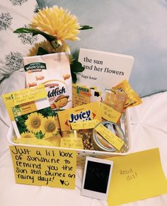 a white basket filled with lots of different items next to a yellow flower and post it notes