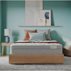 a bed in a room with blue walls and white rugs on the floor next to it