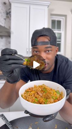 a man in black gloves holding a bowl of food