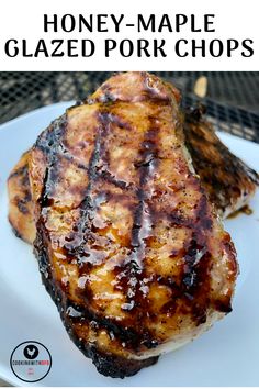 grilled pork chops on a white plate with honey - maple glazeed pork chops