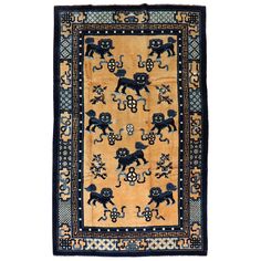 an antique rug with black and yellow animals on it's border, against a white background