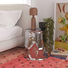 a bed room with a neatly made bed and two vases on the floor next to each other