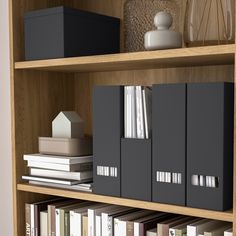 a book shelf filled with lots of books and binders on top of wooden shelves