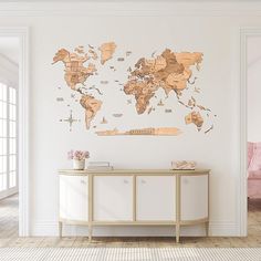 a white room with a large wooden world map on the wall