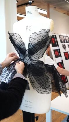 a mannequin being worked on by a woman