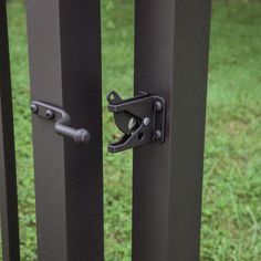 an image of a metal gate that is open and has two latches on it