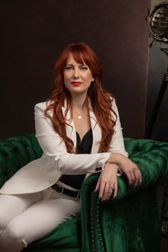 a woman sitting on top of a green chair