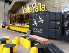 yellow and black tables in front of a restaurant