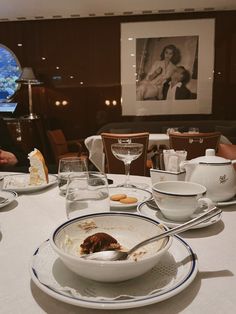 a table with plates, bowls and cups on it