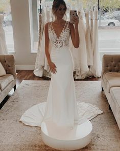 a woman taking a selfie in her wedding dress