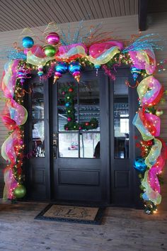 the front door is decorated for christmas with balloons and streamers on it's sides