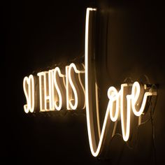 a neon sign that says, so this is cafe on the side of a wall