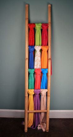 a ladder made out of bamboo sticks with different colored ribbons hanging from the top and bottom