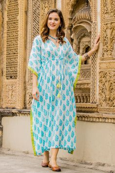 Spend your vacations in a stylish leafy print by Aftab in India. This cotton caftan offers the height of comfort with a flattering waistline. The white cotton garment is adorned with turquoise leaves and trimmed in vibrant green. Charming beaded tassels add a touch of texture. Kaftan Kurti, Kaftan Set, Kaftan Design, Kaftan Tops, Kaftan Designs, Cotton Caftan, Cotton Long Dress, Cotton Kaftan, Trendy Dress Outfits