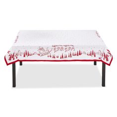 a table covered with a red and white christmas tree design on it's edge