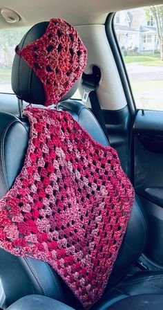 a car seat covered in a crocheted blanket