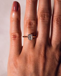 a woman's hand with a ring on it