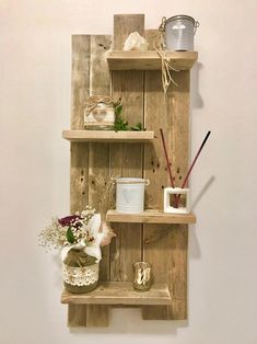 three wooden shelves with candles and other items on them