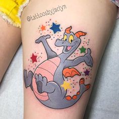 a cartoon character tattoo on the side of a woman's leg, with stars around it