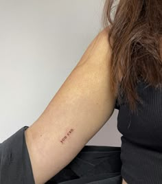 a woman with a small tattoo on her arm