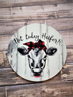 a sign that says, not today heifer on the side of a wooden wall