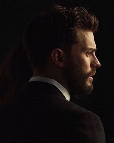 a man in a tuxedo looks off into the distance