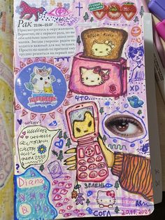 an open notebook with drawings and pictures on the pages, including a cell phone surrounded by other things