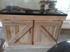 a fish tank sitting on top of a wooden table