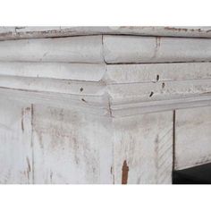 an old white wooden table with peeling paint on the top and bottom part of it