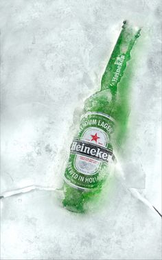 a bottle of heineken beer sitting on top of some ice in the snow