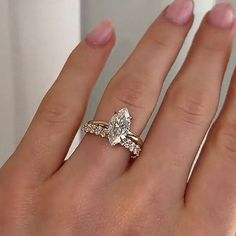 a woman's hand with a diamond ring on her left and an engagement band on her right