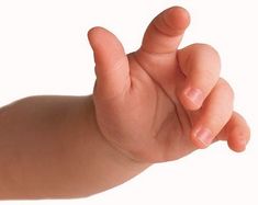 a baby's hand is holding the finger of someones hand, against a white background