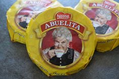 three nestle abuelita coffee cups sitting on the ground