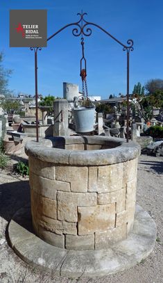 a stone fountain with a bucket on top