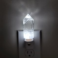 a light that is on the side of a wall with a glass block in it