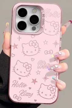 a woman holding an iphone case with hello kitty on it