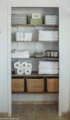 an organized closet with baskets and toilet paper on the shelves, including rolls of toilet paper