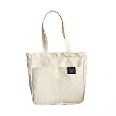 Introducing our Women's Canvas Tote Bag, a perfect blend of style and practicality for the modern woman. Crafted with high-quality cotton, this designer handbag is a versatile accessory that effortlessly transitions from casual outings to beachside adventures. With its solid color design, this tote bag exudes understated elegance. The spacious interior offers a large capacity, allowing you to carry all your essentials and more. Its durable construction ensures it can withstand the demands of eve Trendy Cotton Bag With Large Capacity, Trendy Large Capacity Cotton Bag, Summer Cotton Shoulder Bag With Pockets, Casual Cotton Bag With Large Capacity, Trendy Cotton Shoulder Bag For Travel, Casual Large Capacity Cotton Bag, Trendy Cotton Satchel Bag, Casual Cotton Shoulder Bag With Double Handle, Casual Cotton Canvas Tote Bag