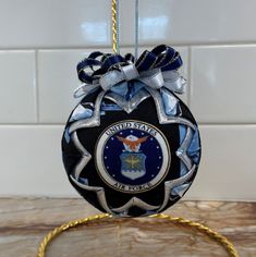 an ornament hanging from a rope in the shape of a ball with a seal on it