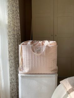 two large bags are stacked on top of each other in front of a closet door