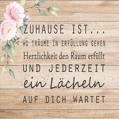 a wooden sign with flowers on it and the words zuhause ist in german