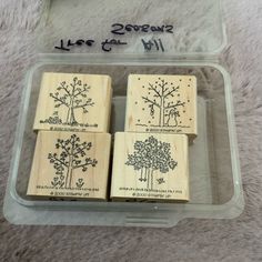 three rubber stamps with trees on them in a plastic container