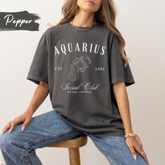 Embrace your Aquarius pride with our exclusive Aquarius Zodiac Sign T-shirt, featuring a captivating Aquarius figure and the bold insignia 'Aquarius Social Club'. Crafted with premium quality fabric, this shirt is the perfect way to showcase your astrological spirit and stand out in style. Customize it and make it a perfect gift for your friends and family.  Note: The font colors will match the pictured shirt colors. (See images for matching font colors) .: 100% ring-spun cotton .: Medium fabric Raccoon Tshirt, Galaxy Shirt, Vintage Cartoons, Tummy Ache, Feyre And Rhysand, 90s Shirts, Meme Tshirts, Espresso Martini, Negroni