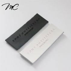 two black and white business cards sitting next to each other