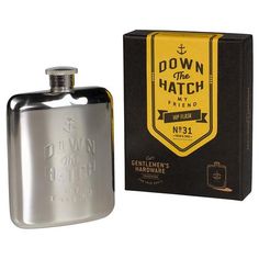 a stainless steel flask with the words down the hatch on it next to a box