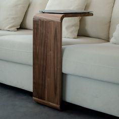 a wooden table sitting on top of a white couch