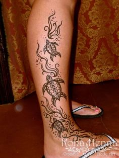 a woman's legs with tattoos on them