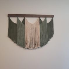 a wall hanging with fringes on it