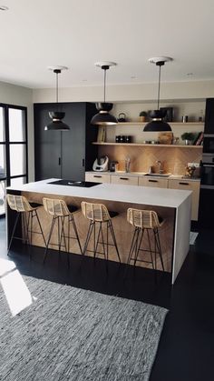 a kitchen with an island and bar stools